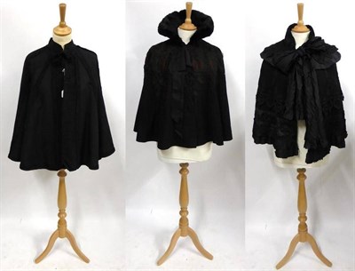 Lot 2176 - Six Victorian Capes including a black silk cape with sequin and black trim appliques; heavily...