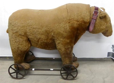 Lot 7 - Large Early 20th Century Bear on Wheels 'Carson', bearing button to his left ear, yellow plush,...