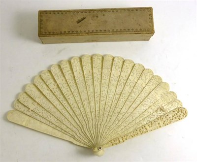 Lot 77 - 18th Century Carved Ivory Brisee Fan decorated with figures and pagodas, 19cm, in a silk lined card