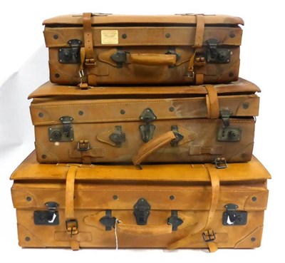 Lot 92 - Graduated Set of Three Giovanni Tan Leather Suitcases with leather straps and metal locks,...