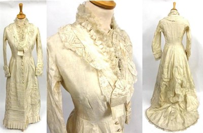 Lot 131 - Late 19th Century Cream Silk Brocade Wedding Dress with long sleeves, pleated detailing to the...