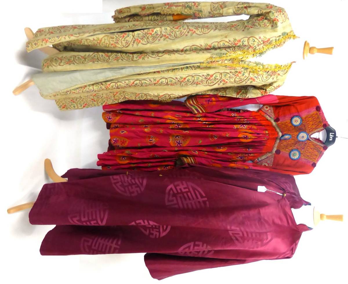 Lot 1252 - Chinese Robe of dark red silk woven with self patterned circular roundels; Eastern Dress with...