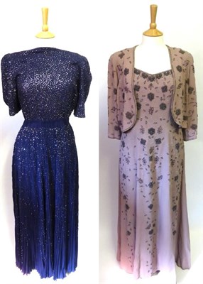 Lot 2058 - Circa 1970's Blue Crepe Long Evening Dress with short sleeves, elasticated waist and decorated with