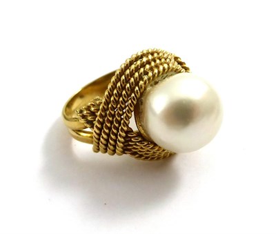 Lot 2152 - A Cultured South Sea Pearl Ring, the pearl within a multiple row rope twist border, on a plain...