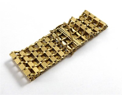 Lot 2157 - A 9ct Gold Bracelet, 1978, a wide textured and polished gate link bracelet, width 2.6cm, length...