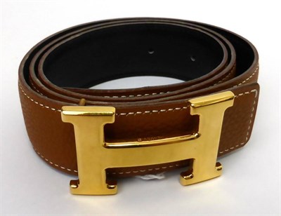 Lot 2170 - Hermes Light Tan/Black Reversible Leather Belt with gilt metal 'H' buckle, with impressed marks...