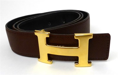 Lot 2171 - Hermes Mid Tan/Navy Reversible Leather Belt with gilt metal 'H' buckle, with impressed marks...