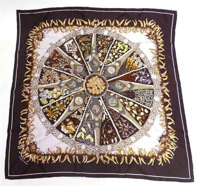 Lot 2176 - Hermes Silk Scarf 'Aux Pays Des Epices' designed by Annie Faivre, on a dark claret ground, 90cm...