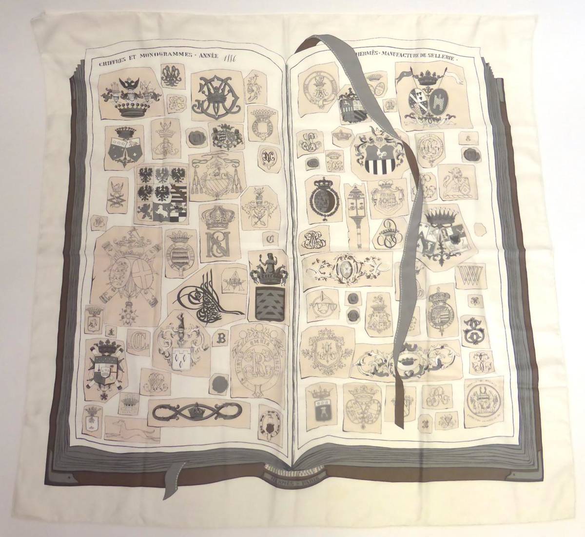 Lot 2179 - Hermes Silk Scarf 'Chiffre et Monogrammes - Annee 1886' designed by Lise Coutin on a white...