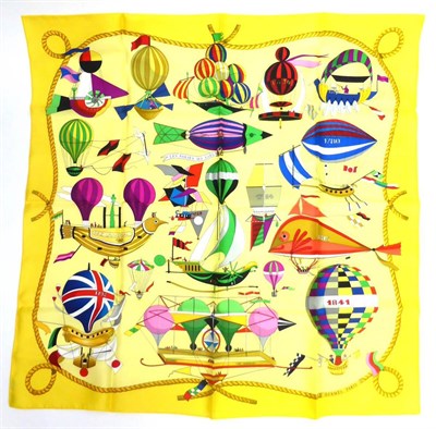 Lot 2187 - Hermes Yellow Silk Scarf 'Les Folies Du Ciel', depicting assorted hot air balloon and 'flying...