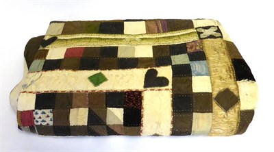 Lot 2008 - A 19th Century Patchwork 'Wedding' Quilt worked in coloured silks and brocades within a brown...