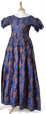 Lot 2119 - 19th Century Blue and Brown Silk Dress woven with floral motifs, with short gathered sleeves,...