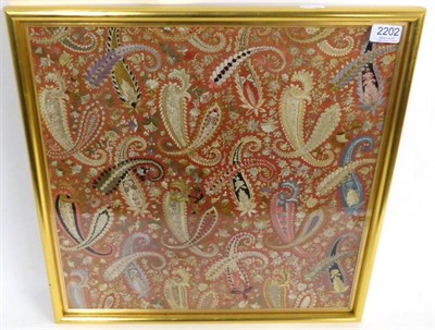 Lot 2202 - Embroidery Sampler using coloured silks over a panel of printed paisley fabric, unfinished,...