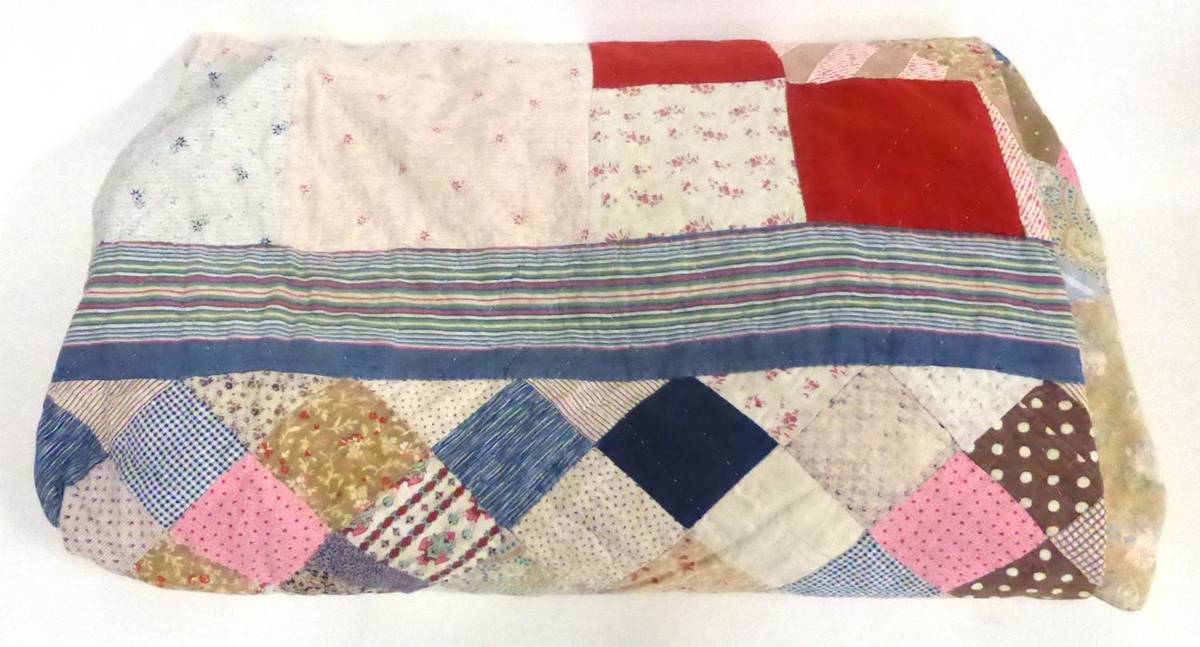 Lot 2026 - Late 19th Century Mosaic Patchwork Quilt, designed with alternating stripes and triangular...