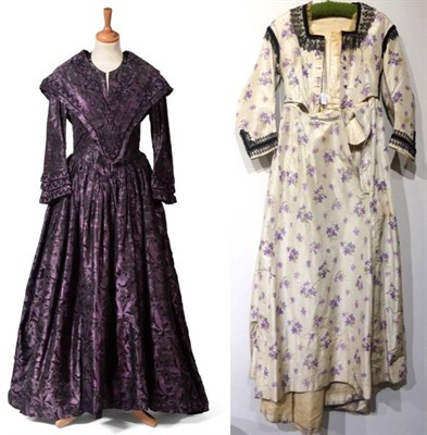 Lot 2139 - 19th Century Purple Silk Dress, of floral design with long sleeves, v shaped panel to the...