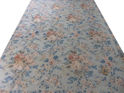 Lot 2193 - A Large Crewel Work Carpet, of floral design on a pale blue/eau de nil ground, with a canvas...