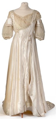 Lot 2118 - Circa 1907 Cream Silk Wedding Dress, with short chiffon silk sleeves mounted with silk tabs to...