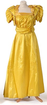 Lot 2134 - Late 19th Century Yellow Silk Two Piece Evening Costume, comprising a fitted bodice with short...