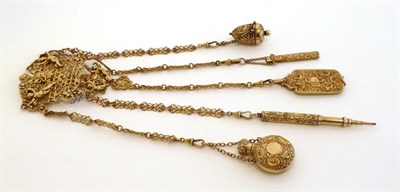 Lot 2073 - A Victorian Silver Gilt Chatelaine by King & Son, London 1894, the cartouche shape clip pierced and