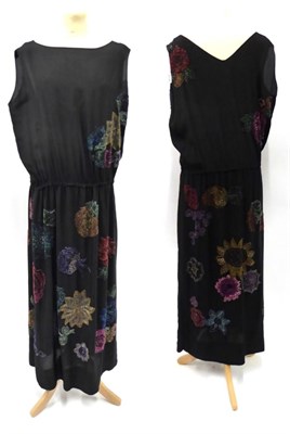 Lot 2190 - Circa 1920s Black Silk Full Length Sleeveless Dress, with drop waist and coloured flowerhead...