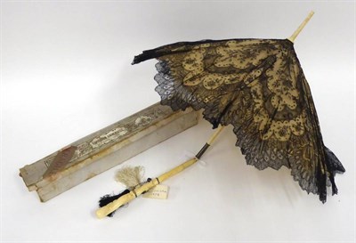 Lot 2221 - A Late 19th Century Folding Ivory Parasol, with carved floral handle, silk mount and black lace...