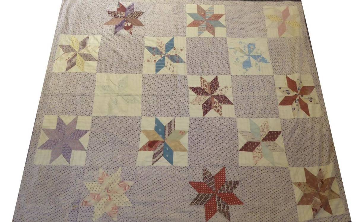 Lot 2009 - Late 19th Century Star Patchwork Cover, using primarily floral sprigged lilac cotton, with a...