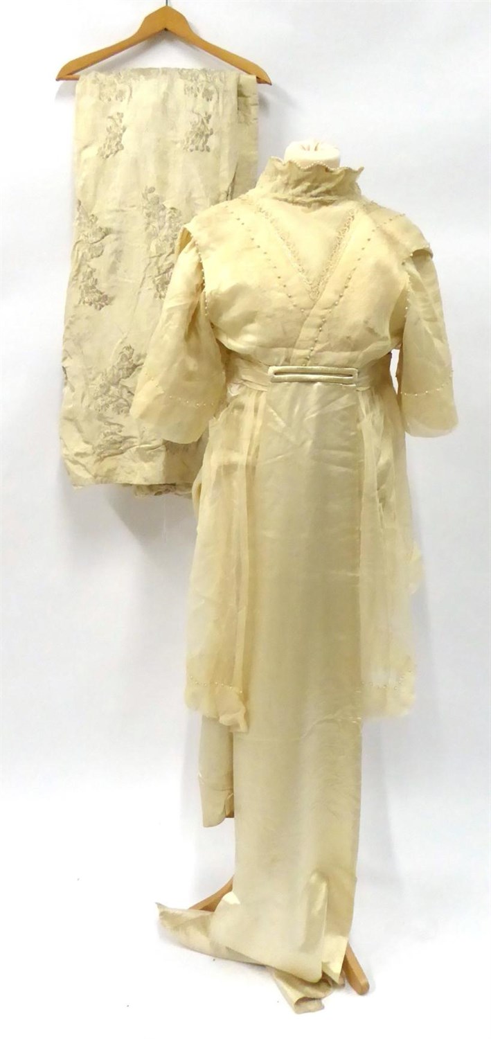Lot 2051 - Early 20th Century Cream Silk Wedding Dress, with lace mounted modesty panel, half sleeves, chiffon