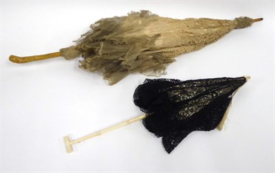 Lot 2064 - Circa 1910 Carved Ivory Parasol, with black lace mount, 58cm; Another with wooden handle, cream...