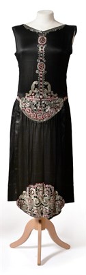 Lot 2117 - Circa 1920s Black Satin Sleeveless Drop Waist Evening Dress, with faux panels to the front and...