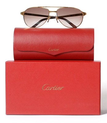 Lot 2167 - A Pair of Cartier 'Santos-Dumont' Edition Sunglasses, with original glasses case, box, care booklet