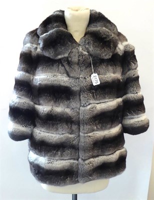 Lot 2175 - Grey Chinchilla Fur Cropped Jacket, the blue lining printed with jewelled crucifix