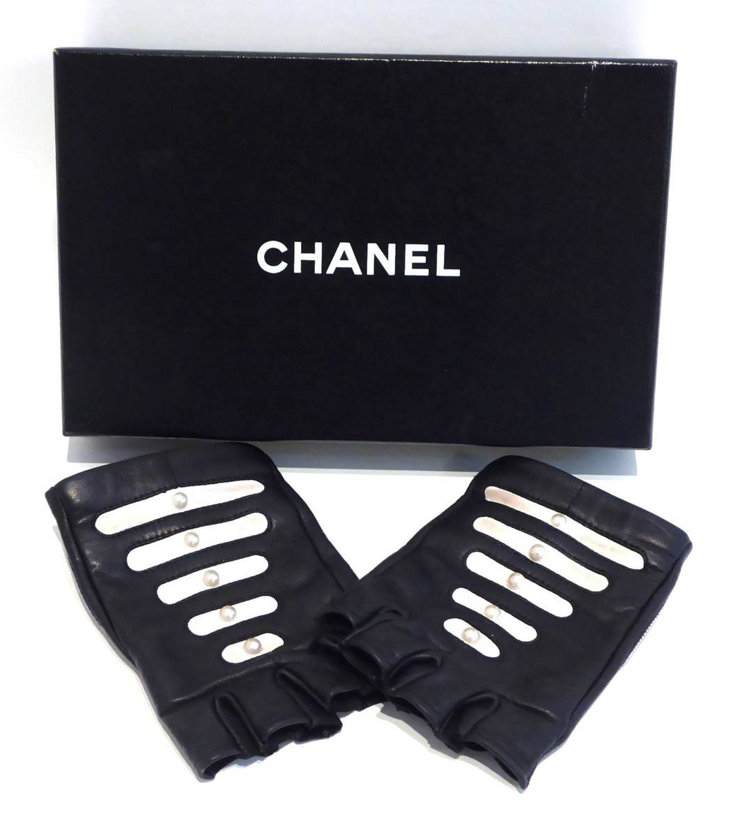 Lot 2196 - Pair of Chanel Black Leather Fingerless Gloves, with white graduated pearl studded panels (size...