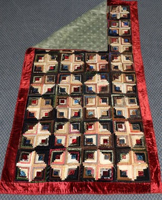 Lot 2079 - Victorian Log Cabin Pattern Bed Cover, incorporating velvets and silks, within a red velvet...