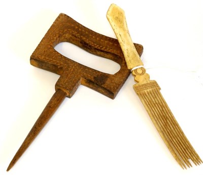 Lot 2091 - Late 19th Century Bone Nit Comb, with carved decoration, 19cm;  and a Treen Rug Prodder, with...
