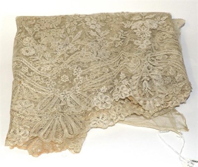 Lot 2105 - Late 19th Century Cream Lace Flounce, appliqued overall with decorative flowers and flower...