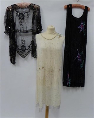 Lot 2136 - Circa 1920s Tunic Style Dress, sleeveless, covered overall in black sequins with purple sequin...