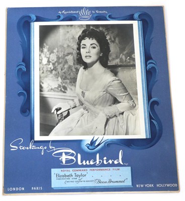 Lot 2169 - Bluebird Stocking Advertising Table Top Board, featuring 'Elizabeth Taylor Fascinating Star of Beau