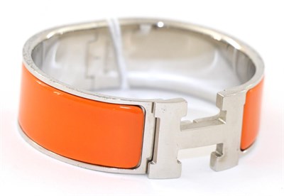 Lot 2189 - Hermes 'Clic-Clac' Orange Enamelled Bracelet/Hinged Bangle, with 'H' clasp, 2cm wide