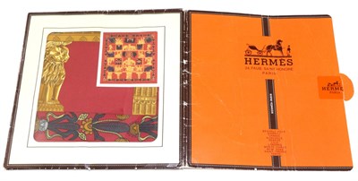 Lot 2249 - A Hermes Silk Scarf Torana, designed by Anne Faivre, with a red ground and border, in a Hermes card