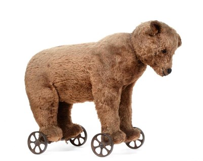 Lot 2005 - Late 19th / Early 20th Century Bear on Metal Wheels, straw filled and with boot button eyes,...