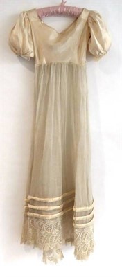 Lot 2056 - Early 19th Century Cream Gauze Evening Gown, with three rows of applied padded trim to match a...