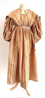 Lot 2059 - 19th Century Pale Pink Silk Day Dress With Matching Shoulder Cape, Circa 1830-1835, woven with...