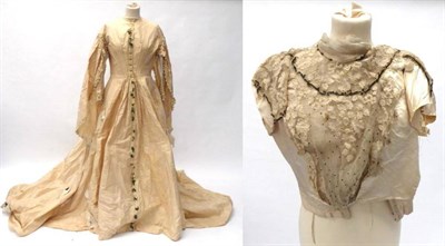 Lot 2076 - Circa 1860's Cream Fitted Wedding Dress, with long shaped over sleeves covering a fitted inner...