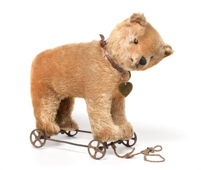 Lot 2002 - Circa 1930 Schuco Yellow Plush Bear on Wheels, with jointed head, stitched nose and claws, boot...