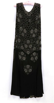 Lot 2125 - Circa 1918 Black Silk Georgette Gown, with silver bead decoration and flared hem