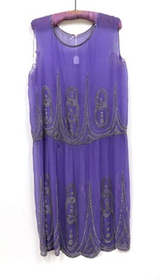 Lot 2127 - Circa 1920s Purple Silk Chiffon Drop Waist Dress, decorated with metallic silver beads and...