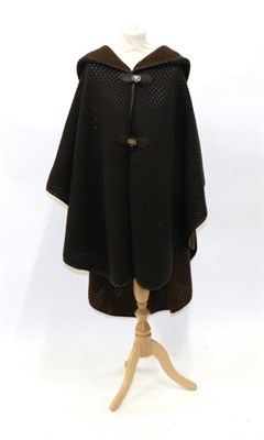 Lot 2205 - Salvatore Ferragamo Wool and Camel Blend Knitted Brown Hooded Cape, the exterior of dark brown,...