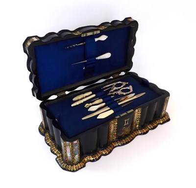 Lot 2073 - A 19th Century Papier-M"°chÅ½ Hinged Sewing Box, with shaped sides, the exterior is inlaid...