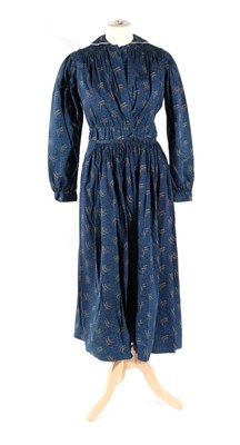 Lot 2117 - Mid 19th Century Blue Printed Cotton Two Piece, comprising a long sleeved jacket with rounded...