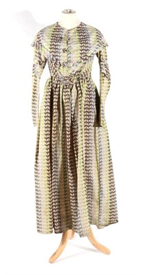 Lot 2122 - Circa 1840 Long Sleeved Dress and Pelerine, in cream wool printed with 'wavy lines' and three...